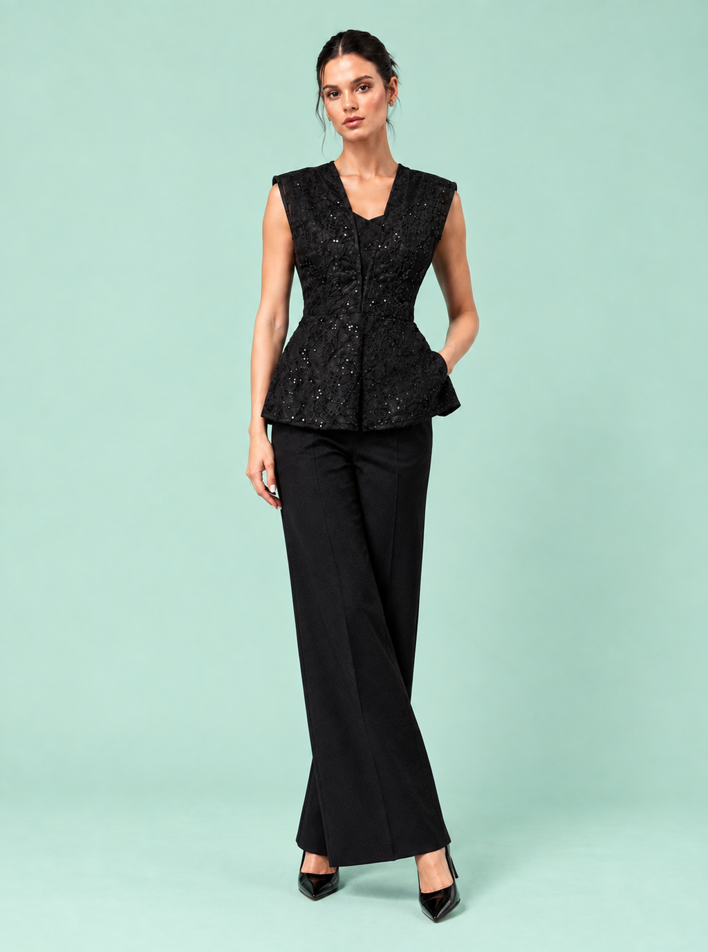 NYX Top side pose — structured peplum designer top The Darling Girl