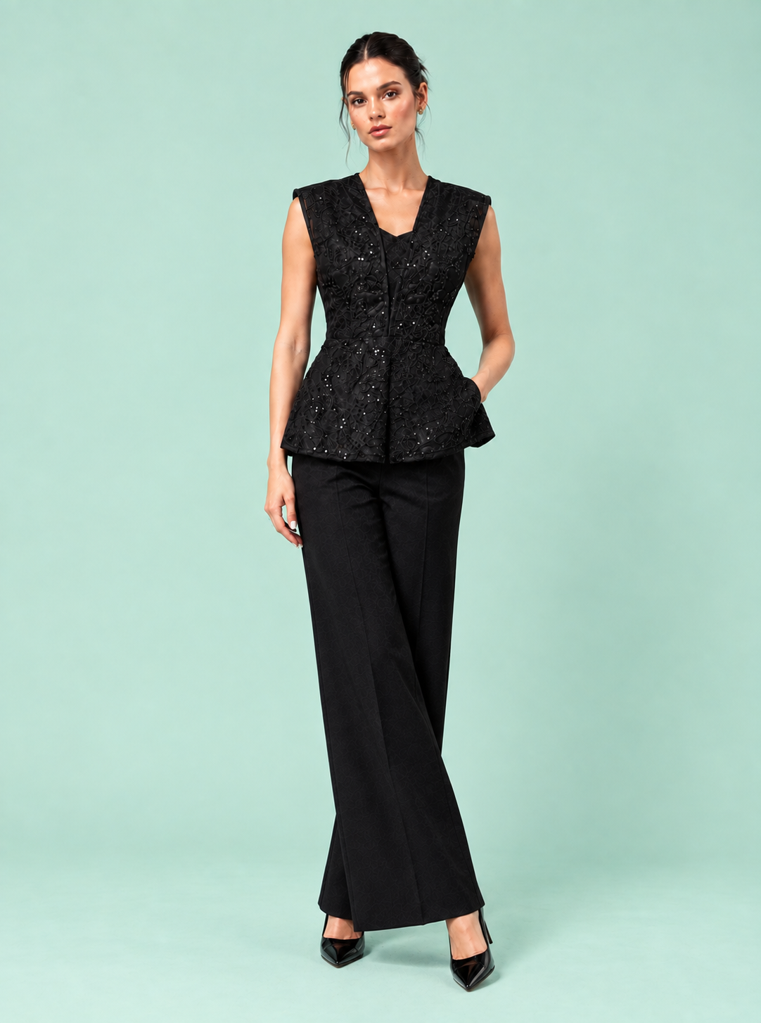 NYX Top side pose — structured peplum designer top The Darling Girl