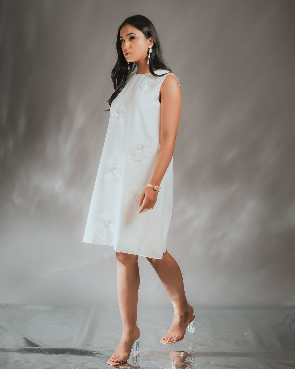 Model wearing a 3D FLOWER DRESS with sequined embroidery, showcasing the dress's elegant design.