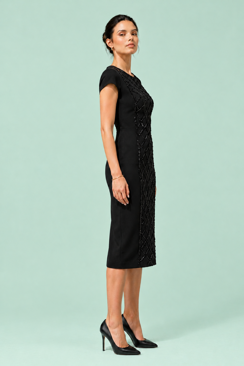 X Dress side pose — sleek black designer midi dress The Darling Girl